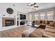 Bright living room with built-in shelving, fireplace, large TV, and comfortable seating at 4129 Fabulous Finches Ave, North Las Vegas, NV 89084