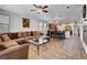 Spacious living area with tile floors, large sectional sofa, and open to dining room at 4129 Fabulous Finches Ave, North Las Vegas, NV 89084