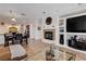 Open-concept living area with fireplace, large TV, dining table, and kitchen view at 4129 Fabulous Finches Ave, North Las Vegas, NV 89084
