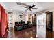Living room with hardwood floors, ceiling fan, projector, and comfortable recliner seating at 4129 Fabulous Finches Ave, North Las Vegas, NV 89084