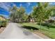 A community park featuring a playground with mature shade trees and lush green grass at 4129 Fabulous Finches Ave, North Las Vegas, NV 89084