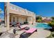 A pool and patio area with lounge chairs in the backyard at 4129 Fabulous Finches Ave, North Las Vegas, NV 89084