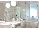 Modern bathroom with marble countertops, glass-enclosed shower, soaking tub and pendant lighting at 4381 W Flamingo Rd # 1907, Las Vegas, NV 89103