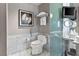 Contemporary bathroom featuring marble tile, toilet, and large glass enclosed sink and vanity at 4381 W Flamingo Rd # 1907, Las Vegas, NV 89103