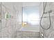 Bright bathroom features a shower and bathtub with modern white-gray marble tiling at 4381 W Flamingo Rd # 1907, Las Vegas, NV 89103