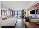 Open-concept condo featuring a bed, living area, and workspace with city views and stylish decor at 4381 W Flamingo Rd # 1907, Las Vegas, NV 89103