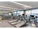 Bright fitness center featuring rows of modern treadmills with skyline views through expansive windows at 4381 W Flamingo Rd # 1907, Las Vegas, NV 89103
