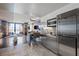 Open-concept kitchen with stainless steel appliances and breakfast bar overlooking living area at 4381 W Flamingo Rd # 1907, Las Vegas, NV 89103
