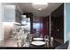 Modern kitchen with stainless steel appliances and a dining area with dark wood furniture at 4381 W Flamingo Rd # 1907, Las Vegas, NV 89103