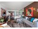 Chic condo living space featuring eclectic decor, a partial kitchen, and a comfortable seating area at 4381 W Flamingo Rd # 1907, Las Vegas, NV 89103