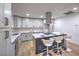 Modern kitchen with white cabinetry, stainless steel appliances, and a center island with seating at 4667 E Boston Ave, Las Vegas, NV 89104