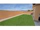 Low-maintenance backyard features synthetic grass, desert landscaping, and stunning mountain views at 4780 Lorenzo Way, Pahrump, NV 89061
