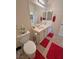 Bathroom with double sinks, a toilet, and tile flooring at 4780 Lorenzo Way, Pahrump, NV 89061
