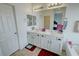 Bright bathroom featuring a double sink vanity, a large mirror, and a separate tub with a door nearby at 4780 Lorenzo Way, Pahrump, NV 89061