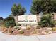 Monument sign for the Mountain Falls community, showcasing lush landscaping and a welcoming entrance at 4780 Lorenzo Way, Pahrump, NV 89061