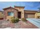 Charming single-story home featuring a stone accent wall, desert landscaping, and a two-car attached garage at 4780 Lorenzo Way, Pahrump, NV 89061