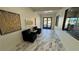 Inviting hallway with elegant tile flooring, art, and comfortable seating, leading to the community gym at 4780 Lorenzo Way, Pahrump, NV 89061