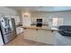 Bright kitchen with white cabinetry, granite countertops, stainless steel refrigerator, and a breakfast bar at 4780 Lorenzo Way, Pahrump, NV 89061