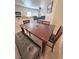 Inviting eat-in kitchen leading to the living area, featuring a dark wood table and black leather bench at 4780 Lorenzo Way, Pahrump, NV 89061