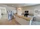 Well-lit kitchen featuring white cabinets, granite counters, stainless steel appliances, and a breakfast bar island at 4780 Lorenzo Way, Pahrump, NV 89061