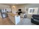 Bright kitchen features white cabinets, granite countertops, stainless steel appliances, and eat-in breakfast bar at 4780 Lorenzo Way, Pahrump, NV 89061