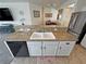 This kitchen features granite countertops, a double sink, a dishwasher, and a view into the living area at 4780 Lorenzo Way, Pahrump, NV 89061