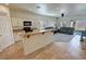 Open-concept kitchen with granite countertops, stainless steel appliances, and an island with breakfast bar at 4780 Lorenzo Way, Pahrump, NV 89061