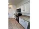 Galley kitchen with white cabinets, granite countertops, and stainless steel microwave and oven at 4780 Lorenzo Way, Pahrump, NV 89061