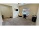 Open living area with a desk and chair near the window, plus a door leading to the rest of the home at 4780 Lorenzo Way, Pahrump, NV 89061