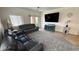Open concept living room with plush carpeting, ceiling fan, and access to the backyard at 4780 Lorenzo Way, Pahrump, NV 89061