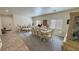 Bright living room with elegant dining set and decor, featuring neutral walls and mixed flooring types at 4780 Lorenzo Way, Pahrump, NV 89061