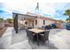 Inviting backyard featuring a covered patio, ample seating, and a well-maintained stamped concrete area at 5014 Sail Rock Pl, North Las Vegas, NV 89031