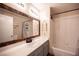 Well-lit bathroom with a wood-framed mirror, vanity, and a shower-tub combination at 5014 Sail Rock Pl, North Las Vegas, NV 89031