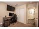 Bedroom featuring a functional workspace, mounted TV, and access to an ensuite bathroom at 5014 Sail Rock Pl, North Las Vegas, NV 89031