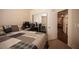 Comfortable bedroom featuring a bed with a plaid comforter and sliding closet doors at 5014 Sail Rock Pl, North Las Vegas, NV 89031