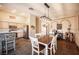 Inviting dining area featuring a rustic table, charming decor, and a view into the kitchen with a stone breakfast bar at 5014 Sail Rock Pl, North Las Vegas, NV 89031