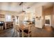 Open dining room connected to kitchen, featuring stylish lighting and a farmhouse table at 5014 Sail Rock Pl, North Las Vegas, NV 89031