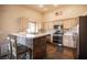 Well-lit kitchen featuring a stone breakfast bar, modern appliances, and ample cabinet space at 5014 Sail Rock Pl, North Las Vegas, NV 89031