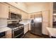 Bright kitchen features stainless steel appliances and a practical design at 5014 Sail Rock Pl, North Las Vegas, NV 89031
