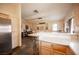 Spacious kitchen features a stone breakfast bar and stainless steel refrigerator at 5014 Sail Rock Pl, North Las Vegas, NV 89031