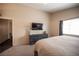 Inviting main bedroom featuring a TV, dresser, and cozy carpeting for relaxation at 5014 Sail Rock Pl, North Las Vegas, NV 89031