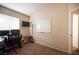 Bright office area with a desk, chair, and whiteboard for creative work and organization at 5014 Sail Rock Pl, North Las Vegas, NV 89031