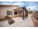 Extended covered patio with ceiling fan and comfortable seating offers an ideal place to relax and enjoy the backyard view at 5014 Sail Rock Pl, North Las Vegas, NV 89031