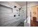 Contemporary tiled shower with dual shower heads, glass partition, and built-in shelving at 5014 Sail Rock Pl, North Las Vegas, NV 89031