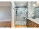 Modern bathroom with marble tiled shower and a wood vanity with white marble countertop at 508 Indian Princess Dr # 104, Las Vegas, NV 89145