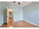 Bright, empty bedroom features wood floors, neutral paint, and view to connecting hallway at 508 Indian Princess Dr # 104, Las Vegas, NV 89145