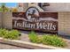Decorative welcome sign featuring 'Indian Wells' amid desert foliage, set against a blue sky at 508 Indian Princess Dr # 104, Las Vegas, NV 89145