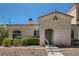 Charming home exterior features an arched entryway, desert landscaping, and neutral stucco siding at 508 Indian Princess Dr # 104, Las Vegas, NV 89145