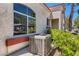 Exterior shot of a stucco home featuring lush green landscaping and a large arched window at 508 Indian Princess Dr # 104, Las Vegas, NV 89145