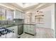 Open kitchen with stainless steel appliances, gray cabinets, granite countertops and breakfast bar at 508 Indian Princess Dr # 104, Las Vegas, NV 89145